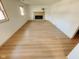 Cozy living room featuring wood floors, a brick fireplace, and plenty of natural light at 439 Pleasantview Dr, Greenwood, IN 46142