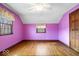Bedroom with hardwood floors, ceiling fan, and natural light from the windows at 4711 Cornelius Ave, Indianapolis, IN 46208