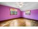 Bedroom with hardwood floors, ceiling fan, and natural light from the windows at 4711 Cornelius Ave, Indianapolis, IN 46208