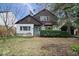 Charming brown and white two-story home with brick accents and mature landscaping on a partially sunny day at 4711 Cornelius Ave, Indianapolis, IN 46208