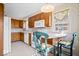Spacious kitchen with breakfast bar, wooden cabinets, and white appliances at 4711 Cornelius Ave, Indianapolis, IN 46208