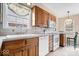 Well-lit kitchen with oak cabinets, white appliances, tiled backsplash, and breakfast bar seating area, perfect for cooking at 4711 Cornelius Ave, Indianapolis, IN 46208