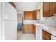 Traditional kitchen with wooden cabinetry, tile backsplash, and white appliances at 4711 Cornelius Ave, Indianapolis, IN 46208