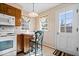 Bright eat-in kitchen with white appliances, a breakfast bar, and lots of natural light at 4711 Cornelius Ave, Indianapolis, IN 46208