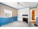 Living room with a ceiling fan and a fireplace surrounded by decorative tile at 4711 Cornelius Ave, Indianapolis, IN 46208