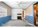 Cozy living room with a ceiling fan and a decorative tiled fireplace at 4711 Cornelius Ave, Indianapolis, IN 46208