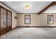 Spacious living room with a beamed ceiling and large windows at 4711 Cornelius Ave, Indianapolis, IN 46208