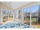 Bright sunroom with tile floor and sliding glass doors to the deck at 4711 Cornelius Ave, Indianapolis, IN 46208