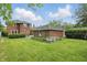 Large backyard with green lawn featuring the home and garage at 4720 Central Ave, Indianapolis, IN 46205