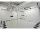Spacious basement with white walls, track lighting, and updated flooring at 4720 Central Ave, Indianapolis, IN 46205