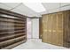 Finished basement area with wood paneling, shelving, and a closet at 4720 Central Ave, Indianapolis, IN 46205