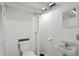 Basement bathroom features a classic pedestal sink, toilet, and mirror at 4720 Central Ave, Indianapolis, IN 46205