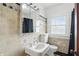 Neat bathroom featuring tile flooring, a mirrored cabinet, and a window for natural light at 4720 Central Ave, Indianapolis, IN 46205