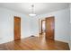 Cozy bedroom featuring hardwood floors, a vintage light fixture and convenient closet space at 4720 Central Ave, Indianapolis, IN 46205