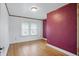 Bedroom featuring hardwood floors, large windows, and ample lighting at 4720 Central Ave, Indianapolis, IN 46205