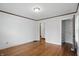 Clean bedroom with wood floors, white walls, closet, and overhead lighting at 4720 Central Ave, Indianapolis, IN 46205