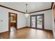 Dining room boasts a chandelier, hardwood floors and a view of the kitchen at 4720 Central Ave, Indianapolis, IN 46205