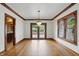 Bright dining room with hardwood floors, chandelier, wood trim, and doors to outdoor patio at 4720 Central Ave, Indianapolis, IN 46205