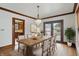 Elegant dining room with a wood table, chandelier and view of the kitchen at 4720 Central Ave, Indianapolis, IN 46205