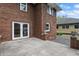 Charming red brick home featuring a walkout concrete patio and decorative accents at 4720 Central Ave, Indianapolis, IN 46205