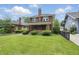 Classic two-story brick home featuring a well-manicured lawn and traditional architectural design at 4720 Central Ave, Indianapolis, IN 46205