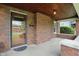 Inviting covered front porch with brick accents and a secure glass front door at 4720 Central Ave, Indianapolis, IN 46205