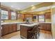 Updated kitchen with stainless steel appliances, center island with seating, and wood cabinets at 4720 Central Ave, Indianapolis, IN 46205