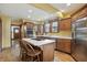 Updated kitchen with stainless steel appliances, center island with cooktop, and wood cabinets at 4720 Central Ave, Indianapolis, IN 46205