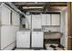 Basement laundry area with washer, dryer, utility sink, and checkered flooring at 4720 Central Ave, Indianapolis, IN 46205