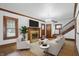 Inviting living room with a cozy fireplace, beautiful hardwood floors, and a crystal chandelier at 4720 Central Ave, Indianapolis, IN 46205
