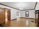 Spacious living room with hardwood floors, classic chandelier and wood trim at 4720 Central Ave, Indianapolis, IN 46205