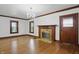 Bright living room with hardwood floors, a fireplace, and two windows offering plenty of natural light at 4720 Central Ave, Indianapolis, IN 46205