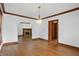 Spacious living room features wood floors, fireplace, wood trim, and decorative chandelier at 4720 Central Ave, Indianapolis, IN 46205