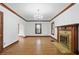 Living room with hardwood floors, a classic chandelier, and fireplace at 4720 Central Ave, Indianapolis, IN 46205