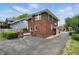 Brick home with a paved driveway and manicured landscaping at 4720 Central Ave, Indianapolis, IN 46205