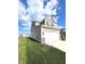 Two-story home with neutral siding, a spacious two-car garage, and a well-kept lawn at 5115 Triple Crown Way, Indianapolis, IN 46237