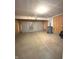 Spacious garage with concrete floor, a closed garage door and room for multiple vehicles at 5115 Triple Crown Way, Indianapolis, IN 46237