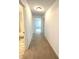 Hallway with neutral carpet leads to bathroom and bedroom at 5115 Triple Crown Way, Indianapolis, IN 46237