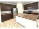 Well-equipped kitchen features stainless steel appliances and spacious island with sink at 5115 Triple Crown Way, Indianapolis, IN 46237