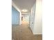 Spacious, carpeted living area with neutral walls and connecting hallways at 5115 Triple Crown Way, Indianapolis, IN 46237