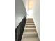 Carpeted staircase with dark wood railing leads to the upper level of the home at 5115 Triple Crown Way, Indianapolis, IN 46237