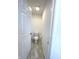 Small toilet room featuring white toilet, a white door, and light tile flooring at 5115 Triple Crown Way, Indianapolis, IN 46237