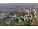 Neighborhood aerial view shows mature trees surrounding beautiful homes on large manicured lots at 5202 Logan Ln, Indianapolis, IN 46250