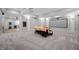 Finished basement with a projector, large screen, seating area, and exercise equipment at 5202 Logan Ln, Indianapolis, IN 46250