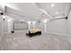 Finished basement with a projector, large screen, and seating area at 5202 Logan Ln, Indianapolis, IN 46250