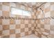 Walk-in shower featuring decorative tile and a built-in bench at 5202 Logan Ln, Indianapolis, IN 46250