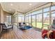 Bright sunroom with wood floors, a ceiling fan, and plenty of natural light at 5202 Logan Ln, Indianapolis, IN 46250