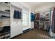 Spacious walk-in closet featuring custom shelving, cabinets, and a window bench at 5202 Logan Ln, Indianapolis, IN 46250