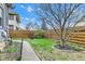 Landscaped backyard features a well-maintained lawn, privacy fence, and a charming garden bed at 524 N Meridian St, Lebanon, IN 46052