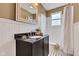 Bright bathroom with wainscoting, neutral walls, a black vanity, and a subway tile shower at 524 N Meridian St, Lebanon, IN 46052